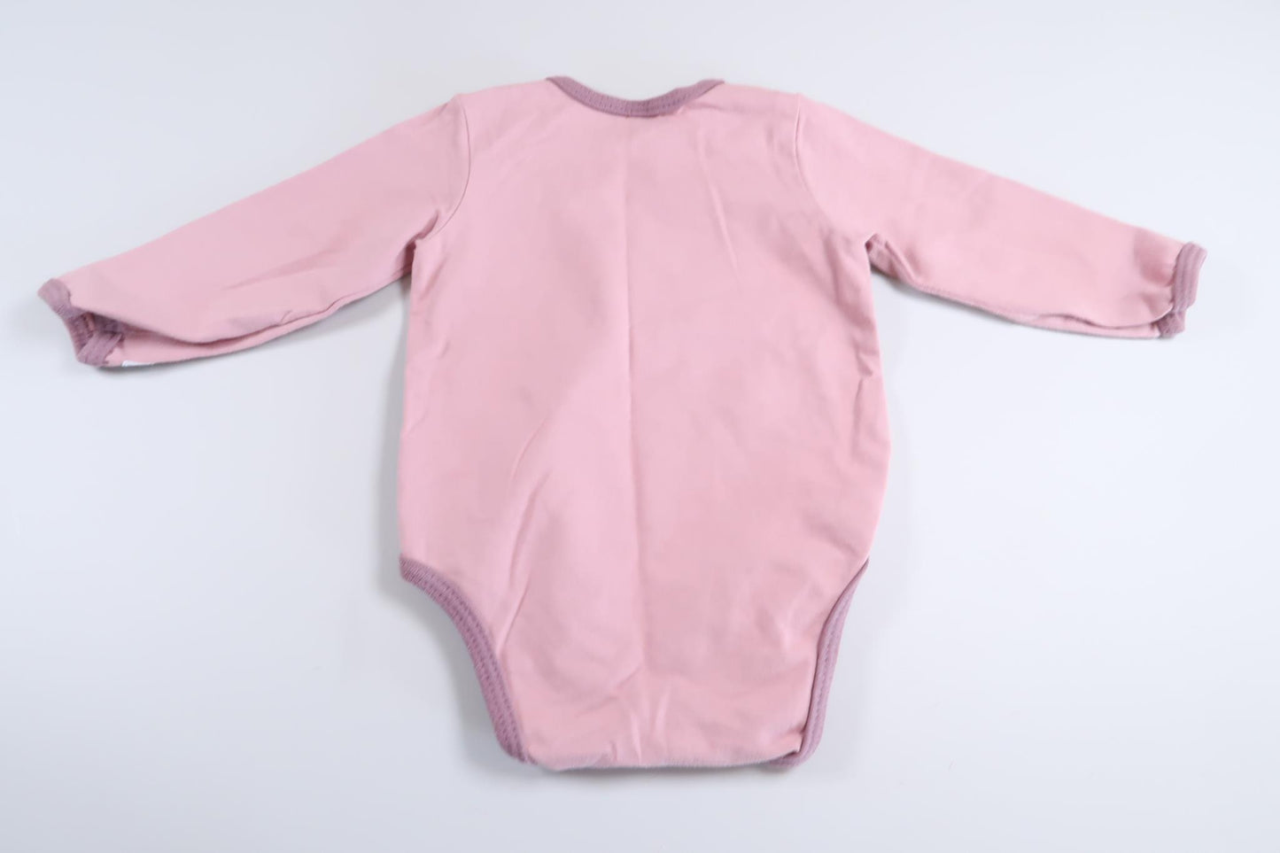 Pink long-sleeved bodysuit in size 68