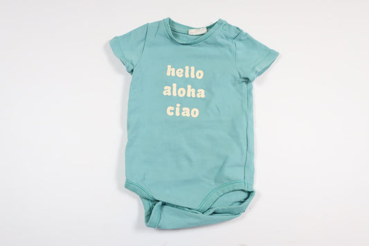 Light blue short-sleeved bodysuit with text from Kappahl in size 62